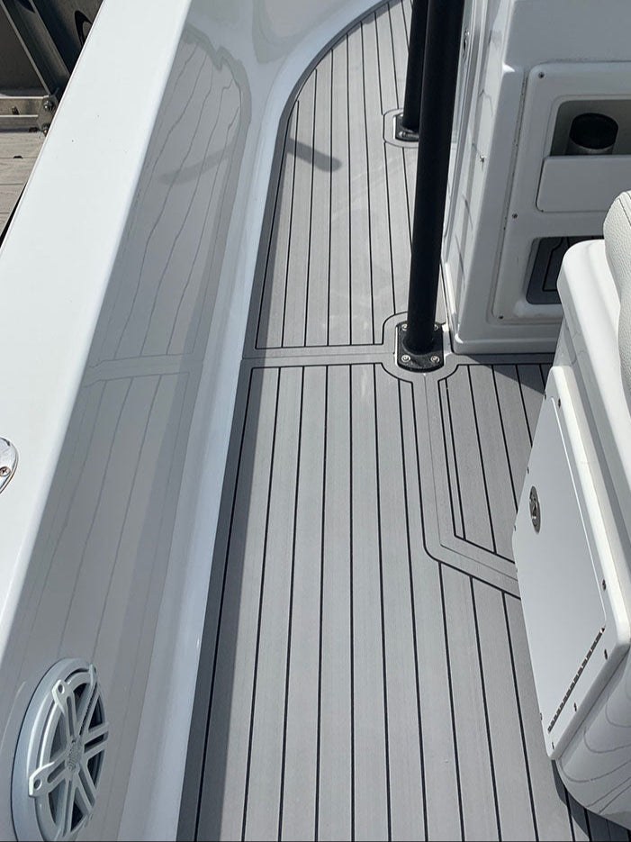 MarineMat grey plank-pattern marine flooring shaped around a boat console and supports