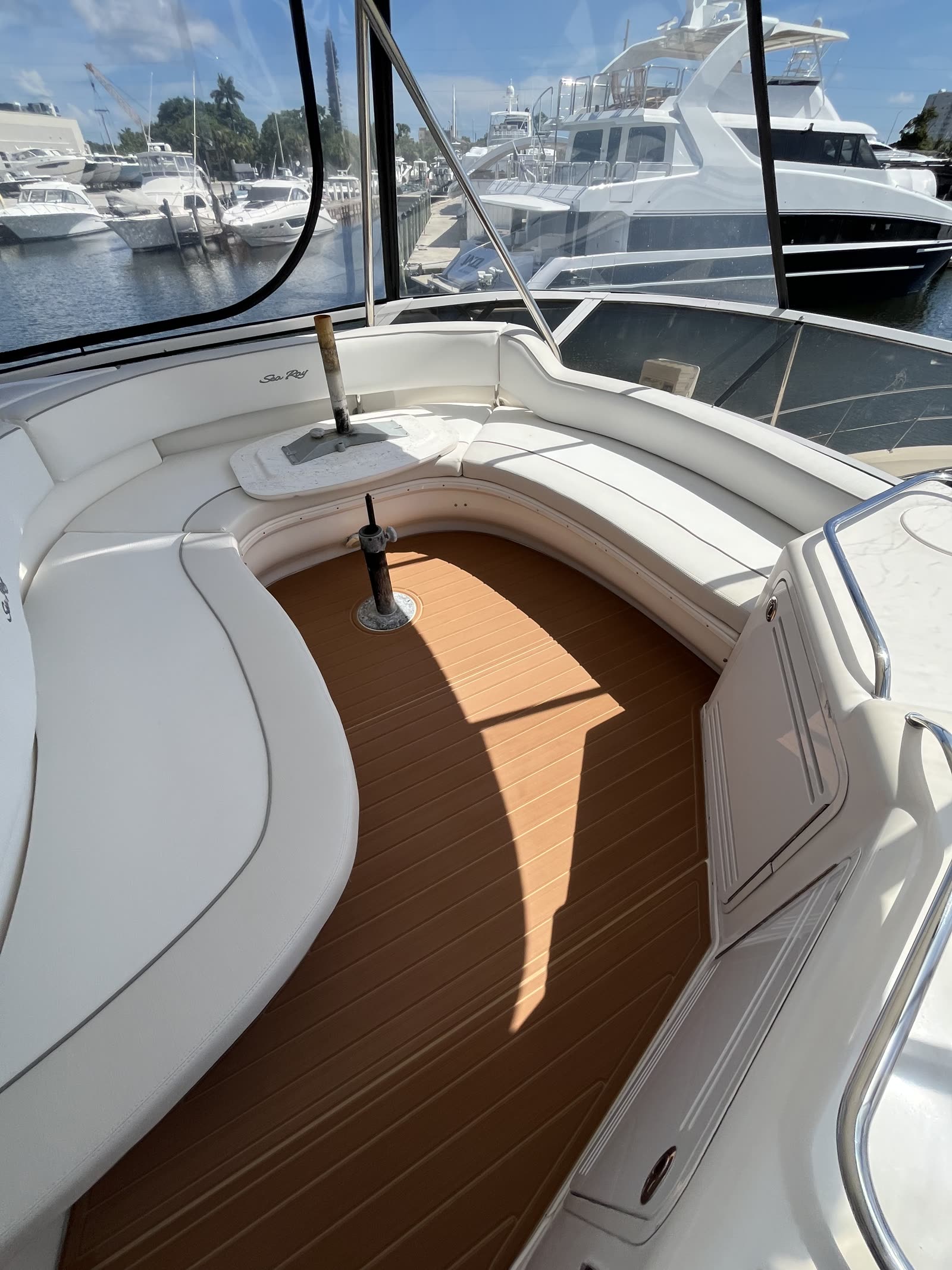 Curved forward seating area on a Sea Ray with synthetic teak sole following the seat radius