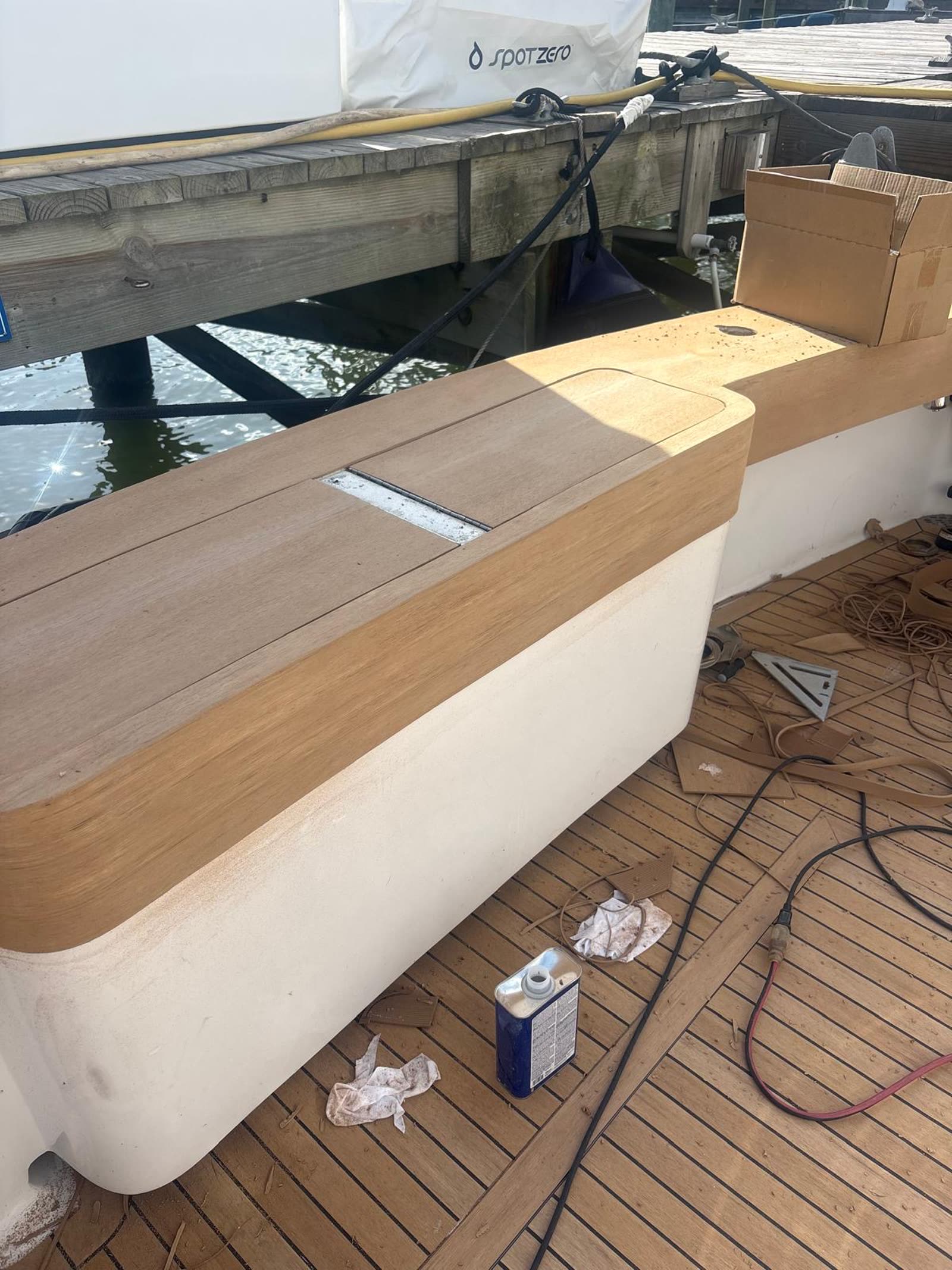 Freshly fabricated synthetic teak coaming top and covering board fitted over the old teak deck