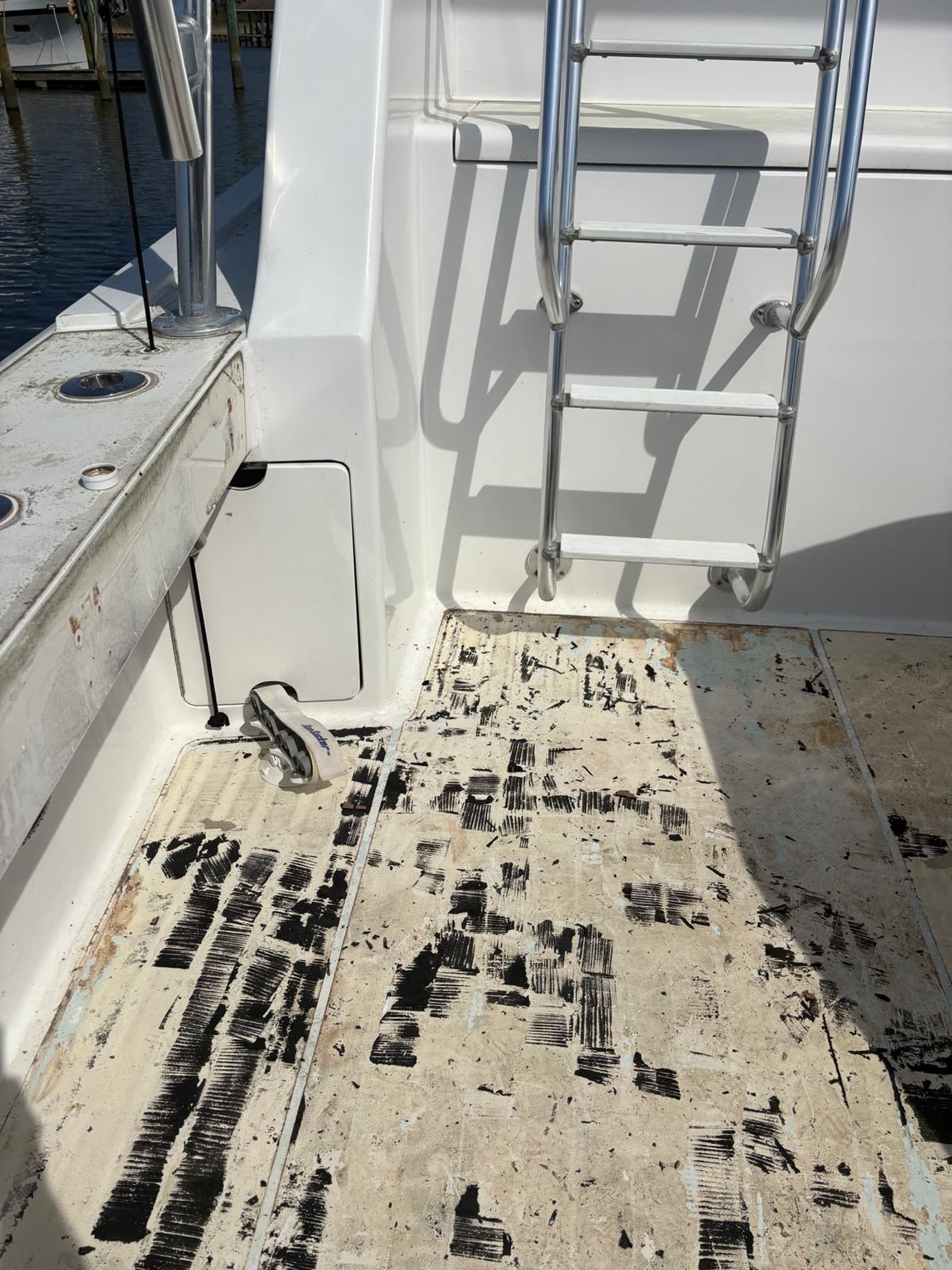 Cockpit stripped to bare fibreglass with black adhesive ridges beside the tuna tower ladder