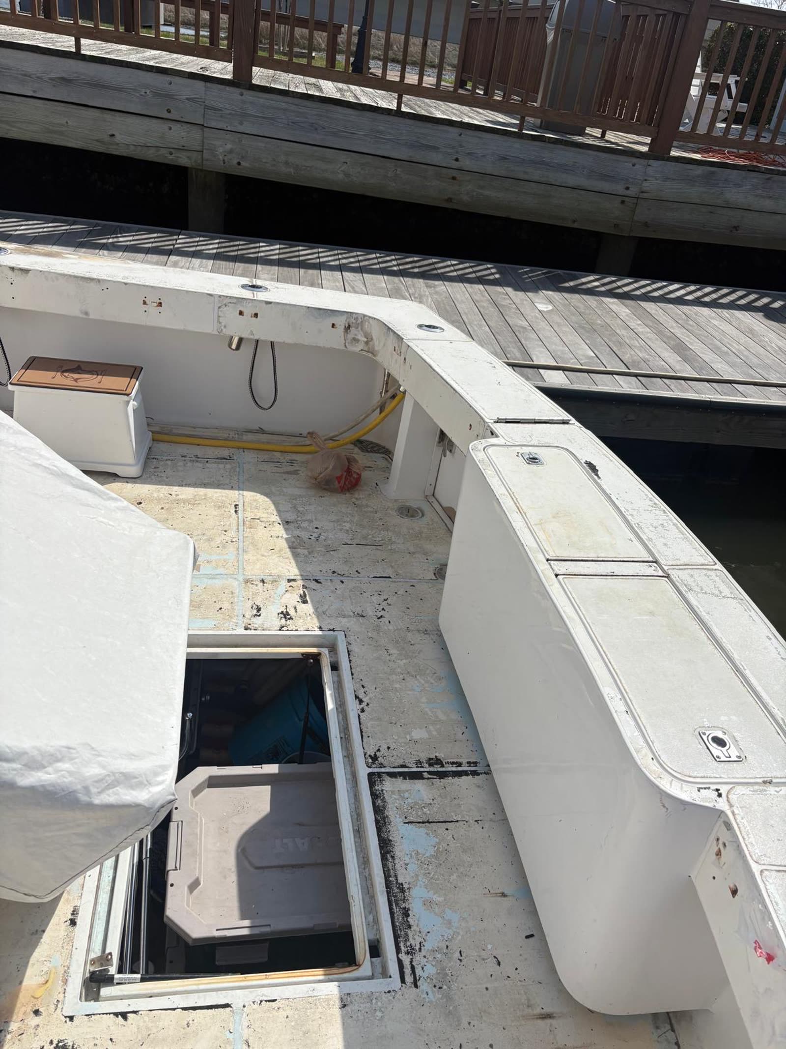 Overhead view of a sportfish cockpit stripped back to bare fibreglass with hatches open before templating