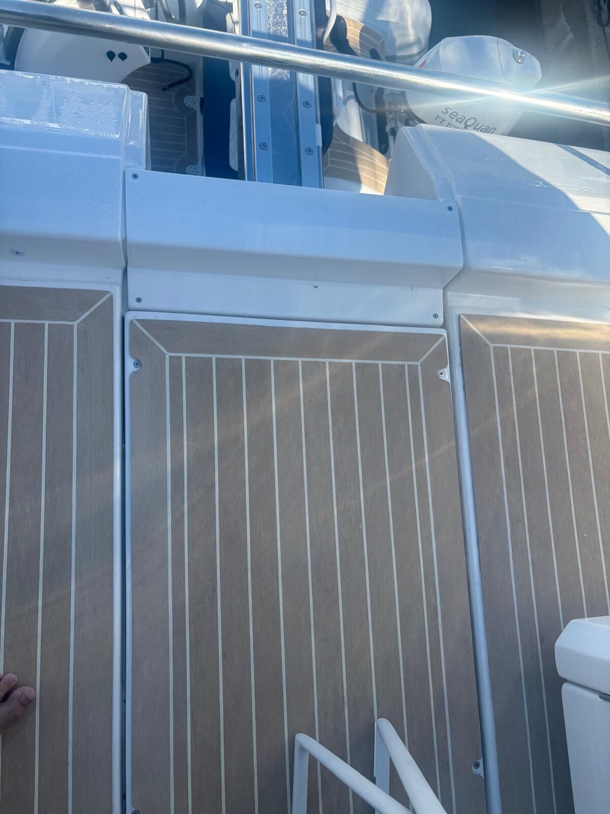 Vertical synthetic teak coaming panels with matched plank spacing and mitred top borders