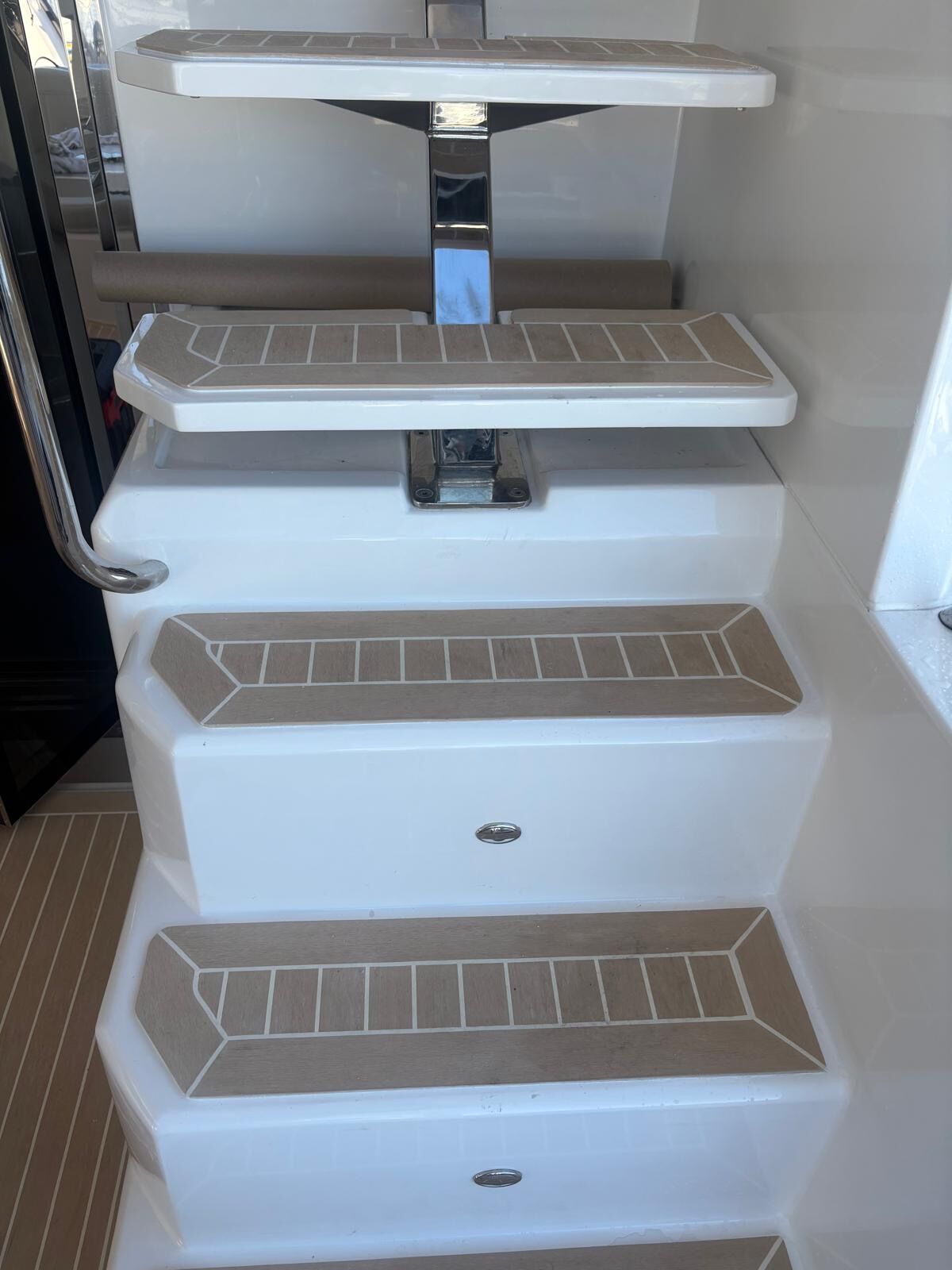 Individual synthetic teak treads with mitred borders fitted to white moulded boarding steps