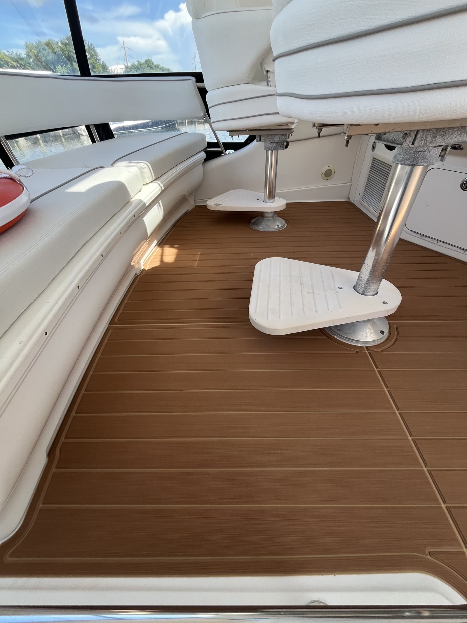 Sea Ray sport cruiser cockpit with new synthetic teak sole laid around seat pedestals