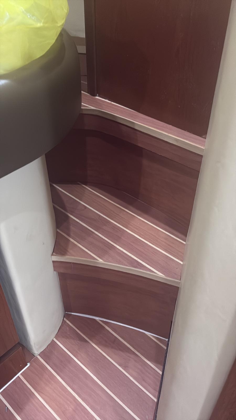 Synthetic teak treads on companionway steps leading down to a lower deck